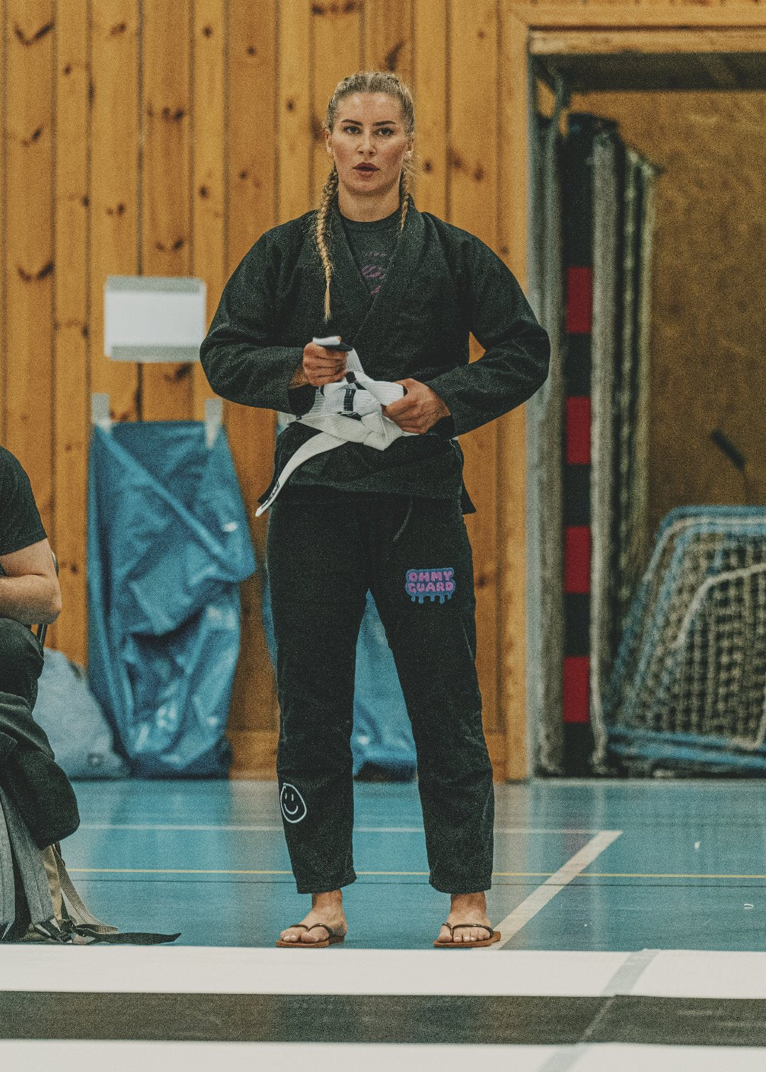 Woman in black kimono ready to compete in bjj