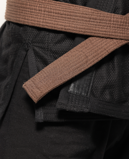 Close up of black kimono and brown belt