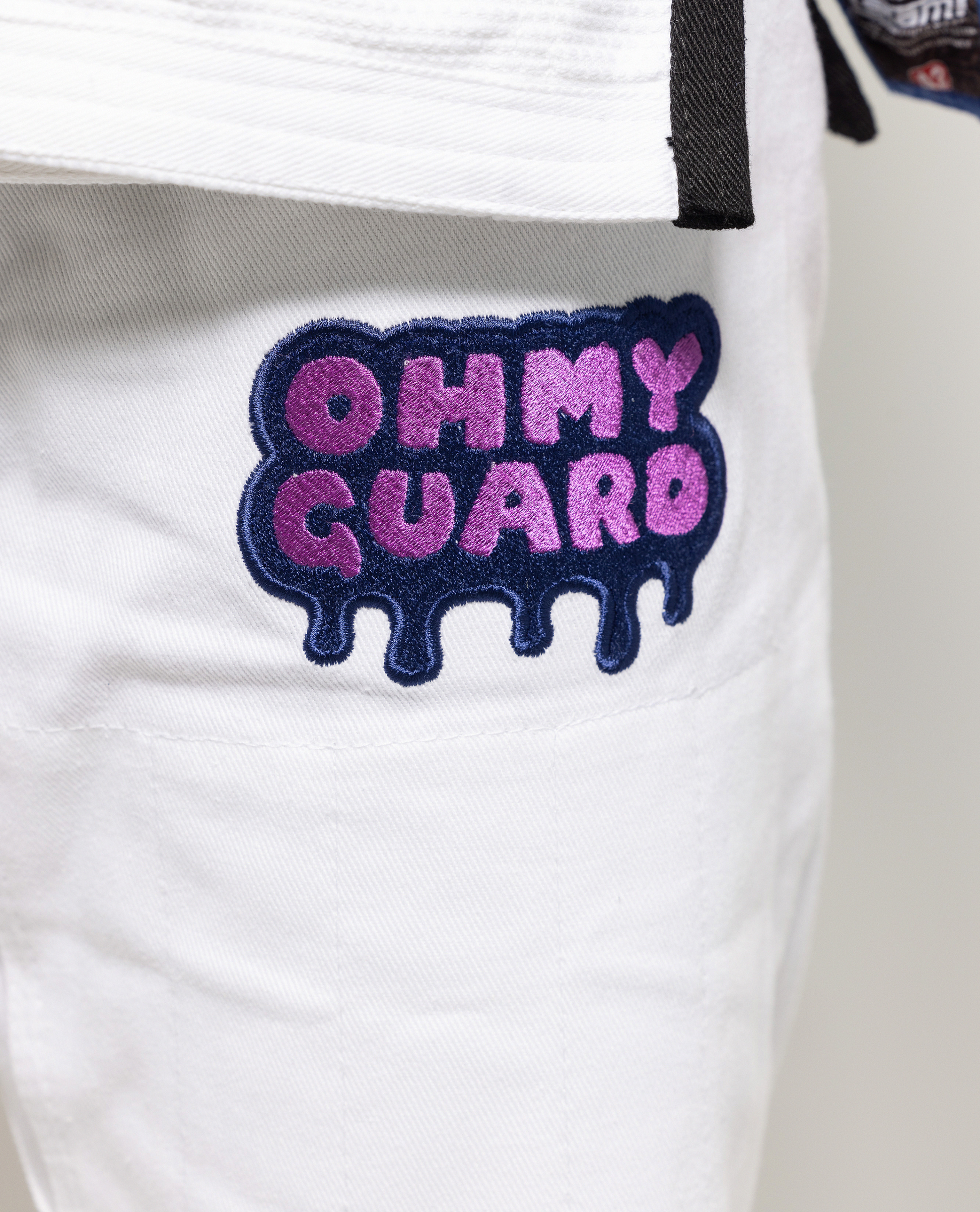 Close up of OhmyGuard logo on white gi pant leg