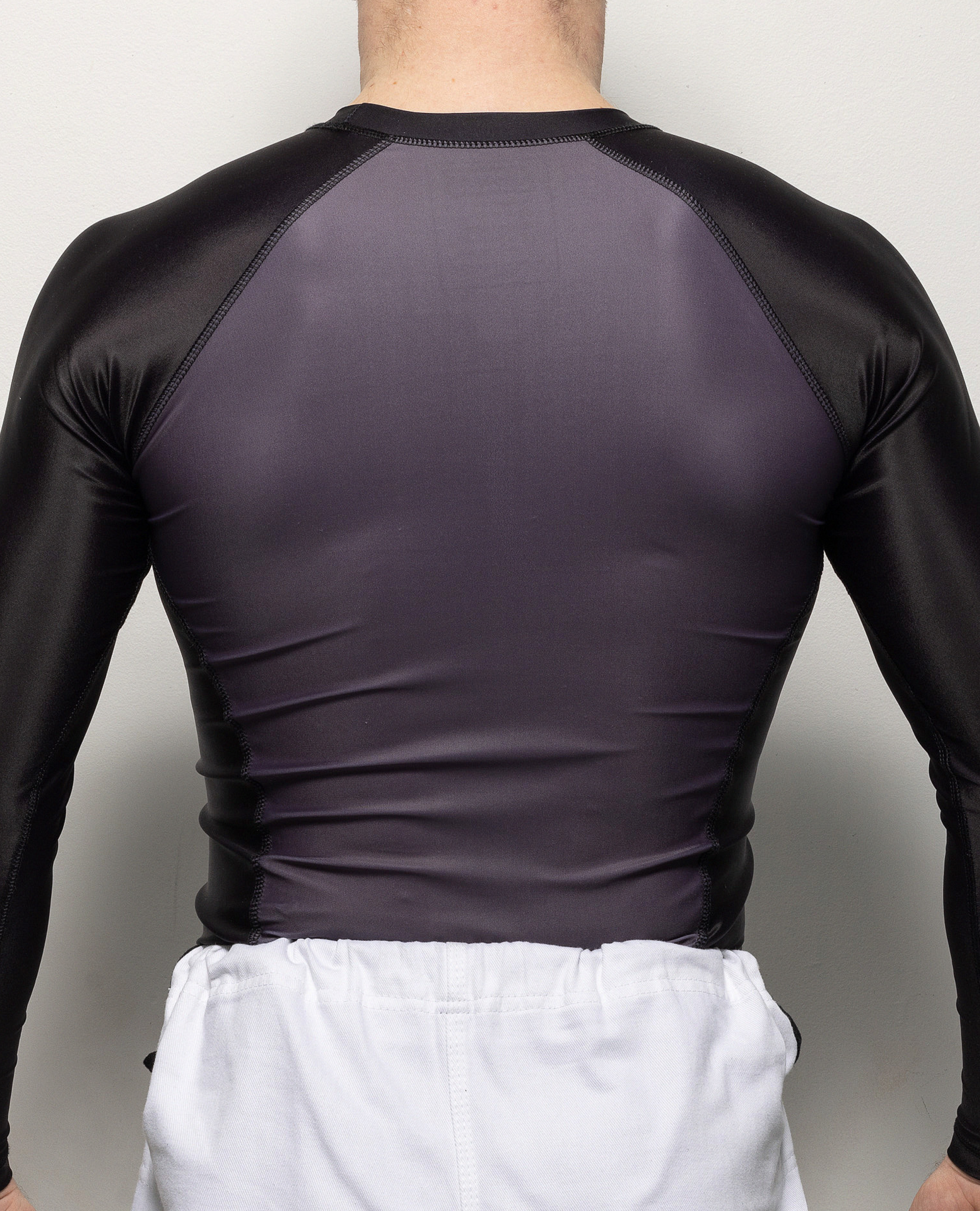 Back view of man in black and gray rashguard