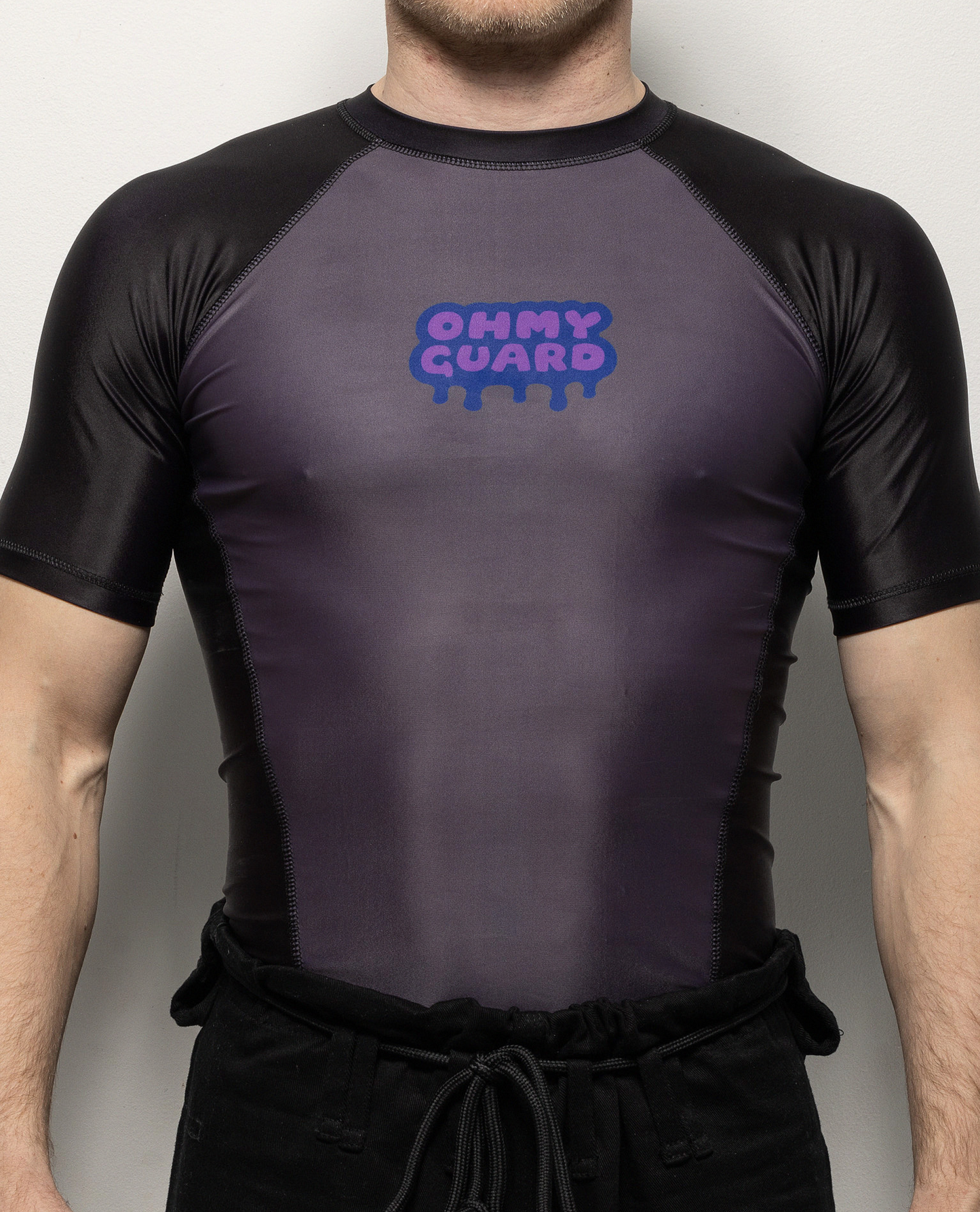 Front view of a man in a black and grey short sleeve rashguard